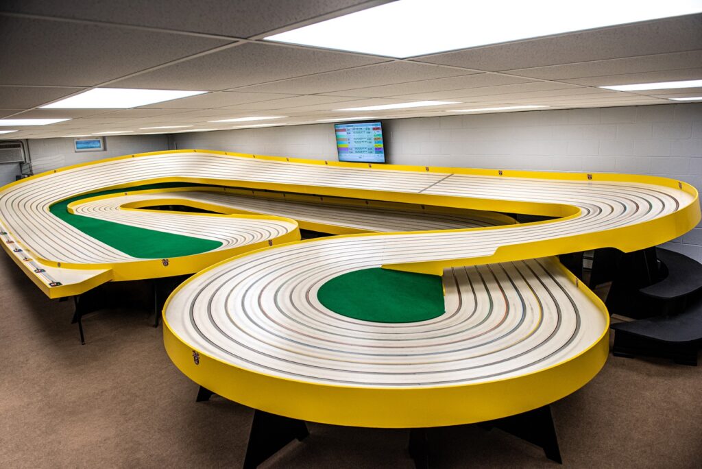 a large yellow commercial 1/24 slot car racing track. 1-24 slot car racing in Cream Ridge NJ Doms Model Car Raceway